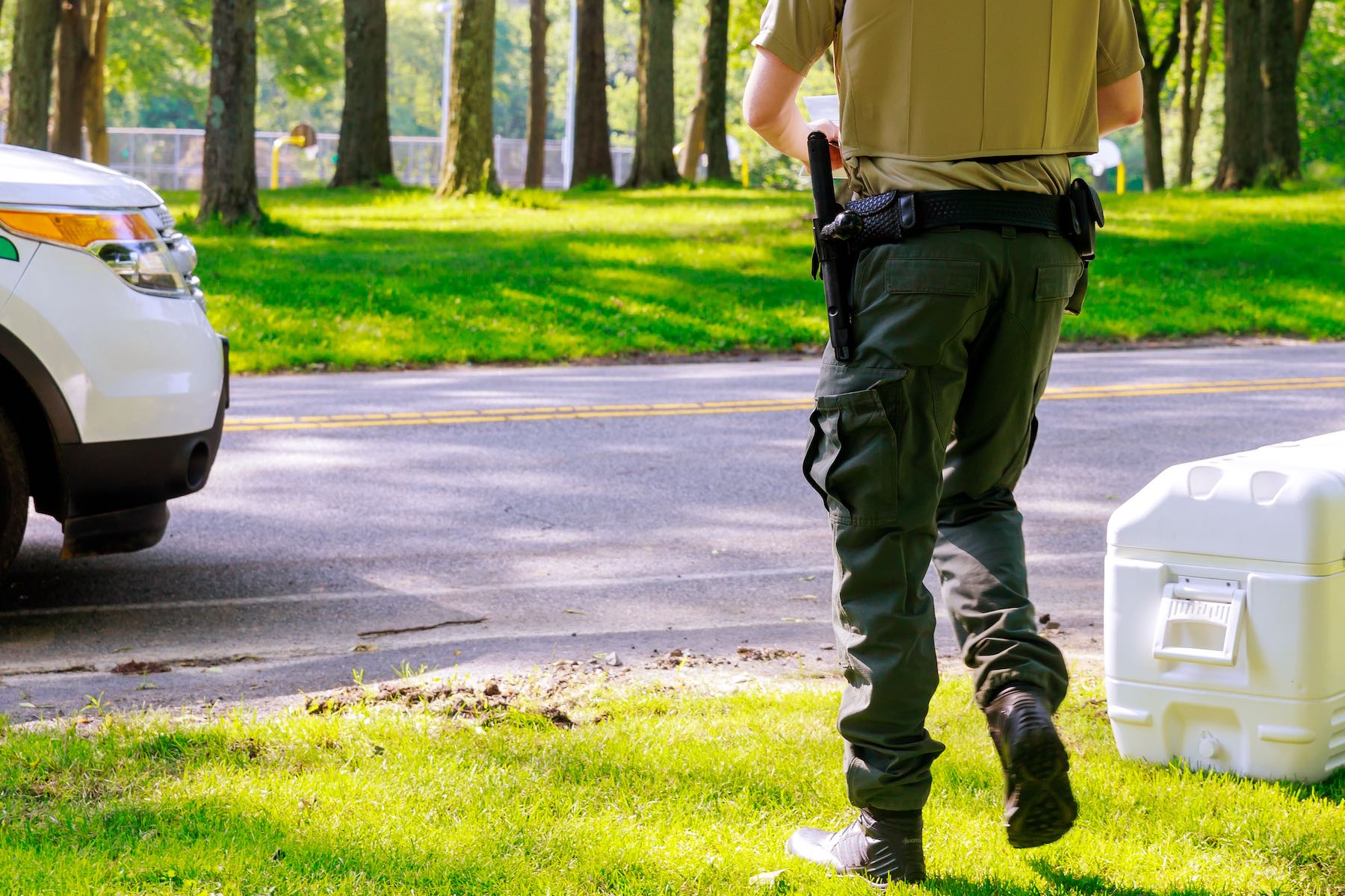 Male security guard in park working with military